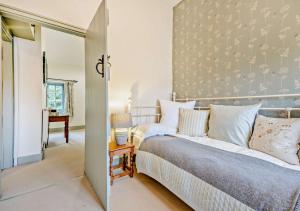 a bedroom with a large bed and a table at Honey Hill House in Docking