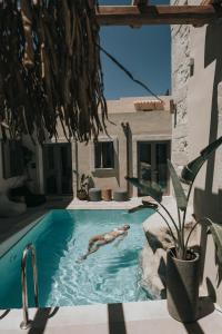 a person swimming in a swimming pool in a house at Manili Boutique Suites & Villas in Archanes