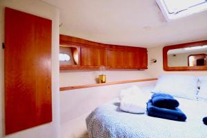 ein Schlafzimmer mit einem Bett mit blauen Handtüchern darauf in der Unterkunft YACHT DEAUVILLE in Deauville
