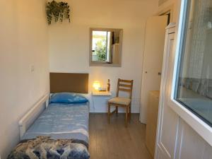 a bedroom with a bed and a chair and a window at VILLA DALU not only Holidays in Trani +27 photos