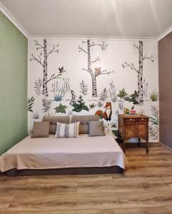 a bedroom with a bed and a wall with trees at NORDIC уютный домик в скандинавском стиле в горах Алматы in Besqaynar