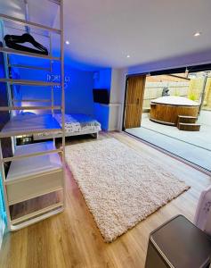 a room with a bunk bed and a rug at Peaceful retreat with hot tub and sauna in Edgware