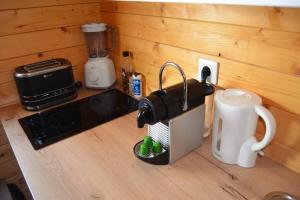 a kitchen counter with a coffee maker and a toaster at La cabane de Robinson à 500m de la plage in Lacanau