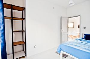 a bedroom with a bed and a room with a mirror at Appartement à Ivandry in Antananarivo