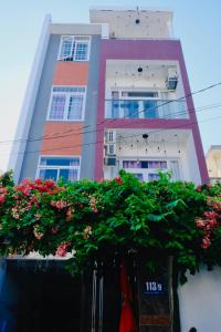 a tall building with flowers in front of it at Simi Homestay in Vung Tau