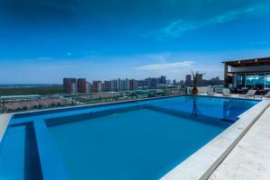 a swimming pool on top of a building with a city skyline at Sky Collection Lifestyle Hotel & Suites Barranquilla in Barranquilla