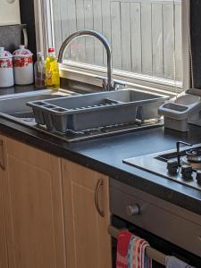 a kitchen counter with a sink and a sink at Colins holiday home in Hull