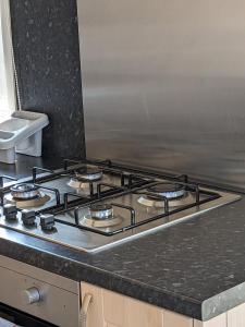 a stove top oven sitting on top of a kitchen counter at Colins holiday home in Hull