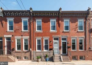a red brick building with white windows and a door at Historic Townhouse Oasis with En-suite Bathroom in Philadelphia