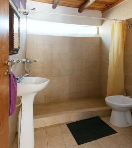 a bathroom with a sink and a toilet at Cabañas Tilcara Taki in Tilcara