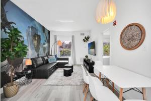 a living room with a couch and a table at Your Pandora - minutes to parks in Orlando