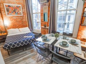 a room with a bed and a table with chairs at Empire Broadway Retreats in New York