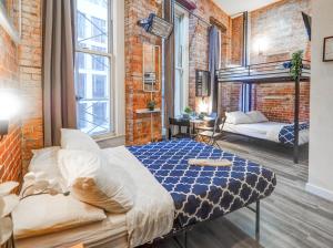 a bedroom with a bed in a brick wall at Empire Broadway Retreats in New York