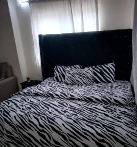 Ένα ή περισσότερα κρεβάτια σε δωμάτιο στο Miraph Apartment
