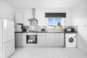 a white kitchen with a sink and a dishwasher at New Luxury Apartment - Cradley Heath - 2MH - Parking - Netflix - Top Rated in Birmingham