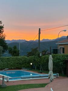a swimming pool with a sunset in the background at B&B LA ROSA in Salerno +48 photos