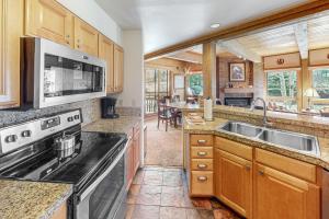 a kitchen with a sink and a stove top oven at Lodge at Steamboat B205 in Steamboat Springs