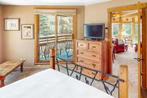 a bedroom with a bed and a tv on a dresser at Lodge at Steamboat B205 in Steamboat Springs