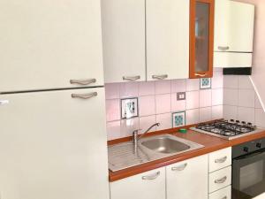 a kitchen with a sink and a refrigerator at Le Case della Costa - Apartment Positano in Maiori