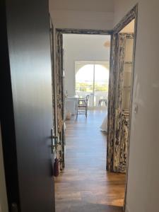 an open door to a living room with a table at Hôtel Paradis in Bormes-les-Mimosas