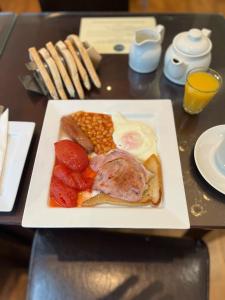 a plate of food with eggs sausage beans and corn at The Wescoe Guesthouse in Blackpool