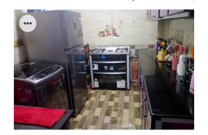 a kitchen with a stove and a refrigerator at Amira Hospitality House in Aswan