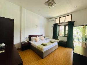 a bedroom with a bed and a large window at Moi Ella by DBI in Ella