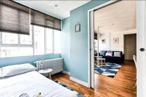 una camera con letto e parete blu di Appartement Love près des Grands Magasins - 6P a Parigi