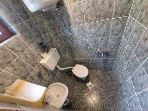 a bathroom with a toilet and a sink at PEKOVIĆ in Bar