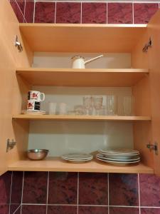 a pantry with plates and glasses on shelves at PEKOVIĆ in Bar +31 photos