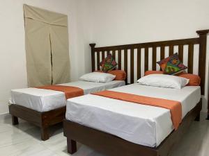 two beds sitting next to each other in a room at Richland's Villa in Kandy