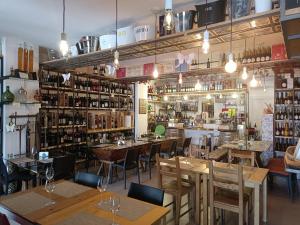 a restaurant with wooden tables and chairs and a bar at B&B Belveliero - Il Capitano in Trapani