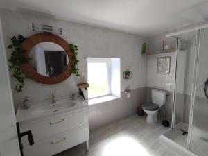 a bathroom with a sink and a toilet and a mirror at Charmes et chic in Charmes