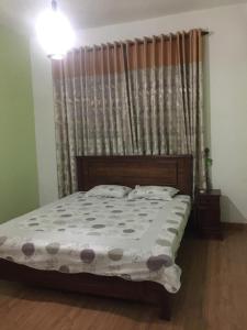 a bedroom with a large bed with a curtain at Lucky Home Kandy in Ampitiya