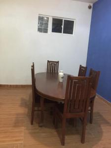 a dining room table and chairs with a candle on it at Lucky Home Kandy in Ampitiya