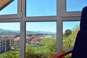 a view of a city from a window at Dúplex El Mochuelo: vistas al casco histórico, mucha luz y plaza de aparcamiento in San Vicente de la Barquera