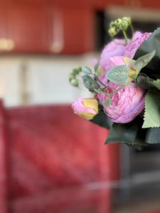 a bouquet of pink flowers on a table at Evansville Holiday House in Evansville