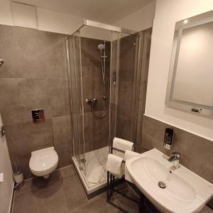 a bathroom with a shower and a toilet and a sink at Trip Inn Hotel Düsseldorf Neuss in Neuss