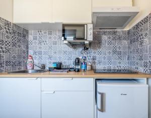 a kitchen with a sink and a counter top at Flow Rooms in Comporta