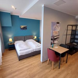 a bedroom with a bed and a table in it at Trip Inn Hotel Düsseldorf Neuss in Neuss