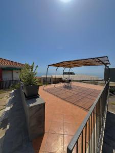 a patio with a picnic table and a canopy at Casa Vista Azzurra in Aci Castello +64 photos