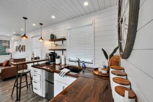 a kitchen with white walls and wooden floors at Bluebonnet Trail in Waco