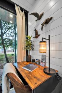 an office with a desk with a laptop and a lamp at Bluebonnet Trail in Waco