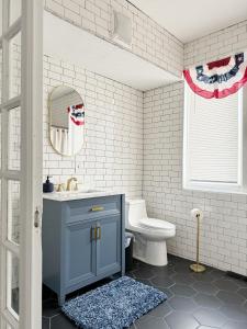a bathroom with a blue cabinet and a toilet at Evansville Holiday House in Evansville