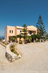 a large house with a stone driveway in front of it at Leyenia Serenity Houses in Kókkinon Khoríon