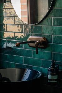 a bathroom sink with a faucet and a mirror at 4 Strony Apartamenty w Wodnej Wieży in Pszczyna