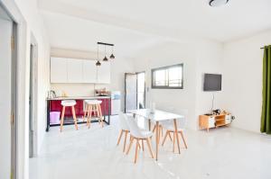 a kitchen and living room with a table and chairs at Appartement à Ivandry in Antananarivo