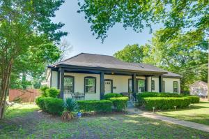a small house with a porch and bushes at Updated Greenwood Cottage Apt Less Than 1 Mi to Dtwn! in Greenwood