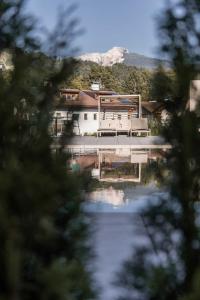 a house with a dock on the water at Michlhaus nature and suites in Aldino