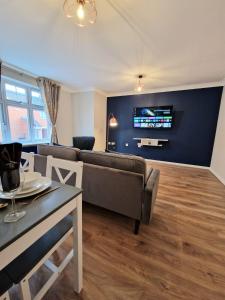 a living room with a couch and a table at Impeccable 2-Bed Apartment in Newcastle upon Tyne in Newcastle upon Tyne